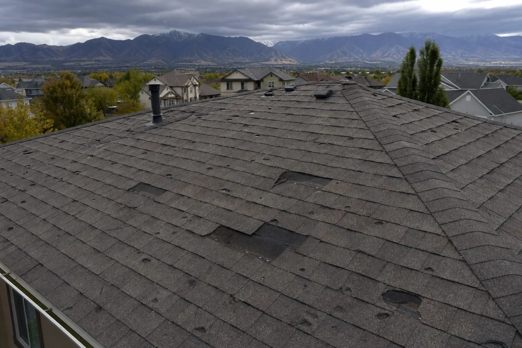 Hail damaged asphalt shingles on a residential roof in South Valley Utah